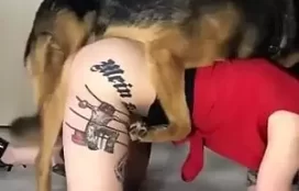 Mulher tatuada rabuda trepando com cachorro